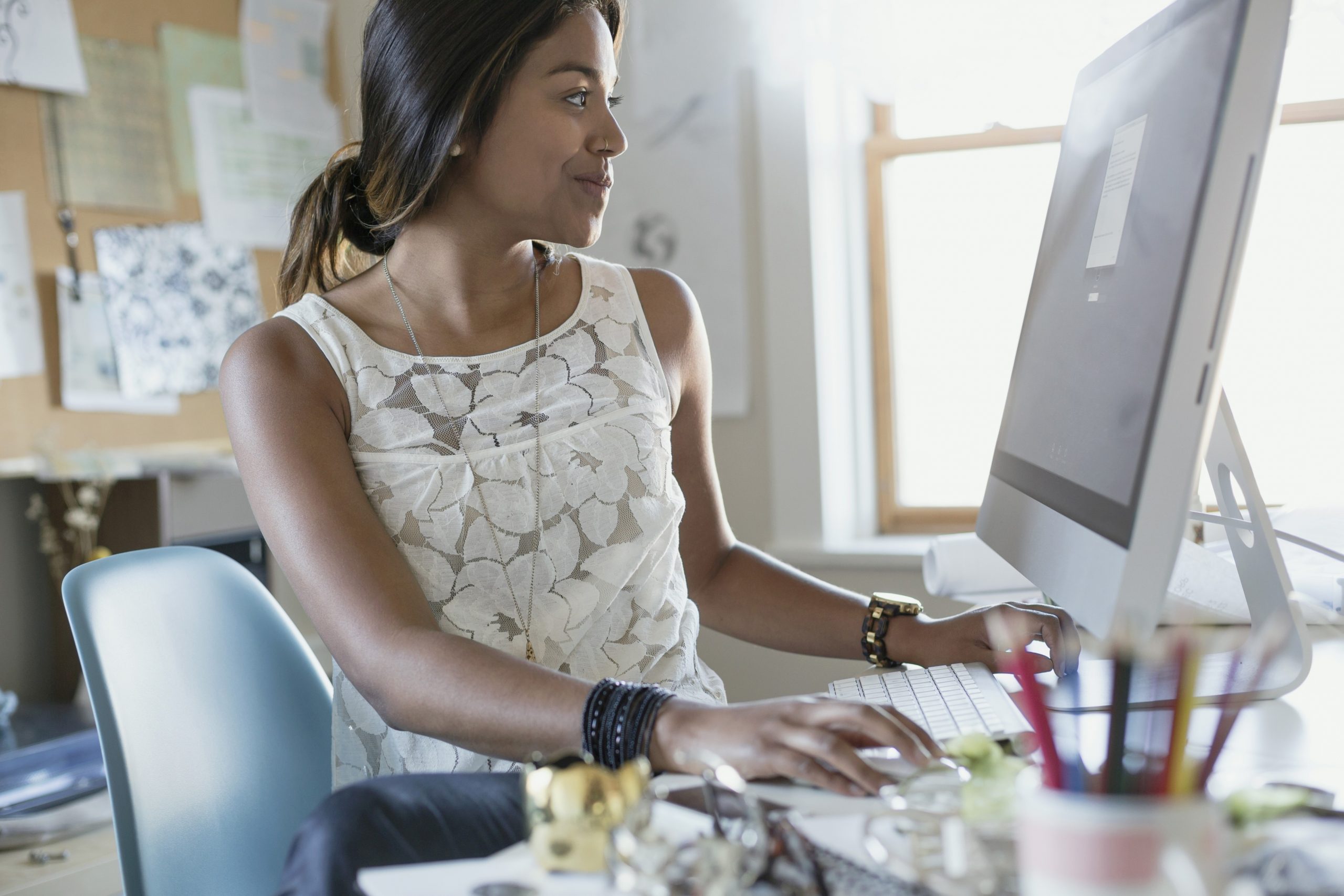 Female designer working at desk in home office